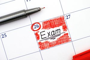 Reminder Exam in calendar with red pen.